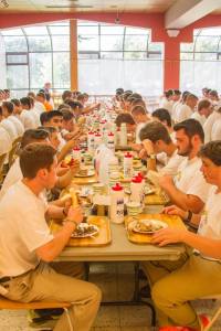 Here the Boys report to dinner for the first time, but only after writing and handing in their letters home first.